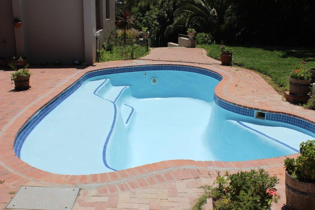 Hout Bay Pool Renovation Hout Bay New fibreglass lining applied to pool ceramic mosaic pool tiles applied to sides, martini seat and step area of pool.